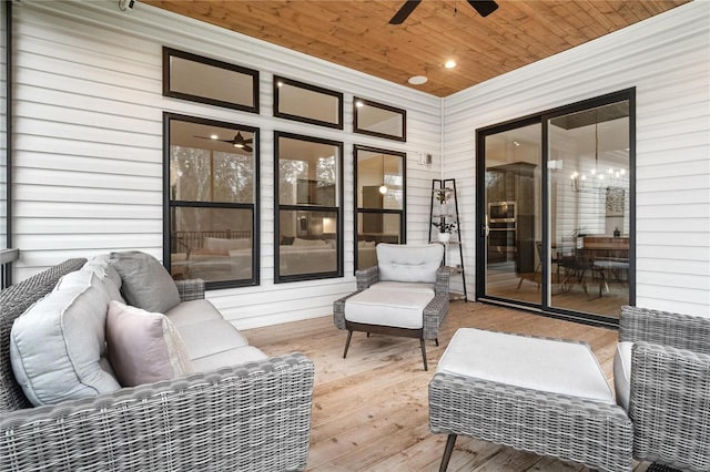 wooden terrace with ceiling fan and an outdoor living space