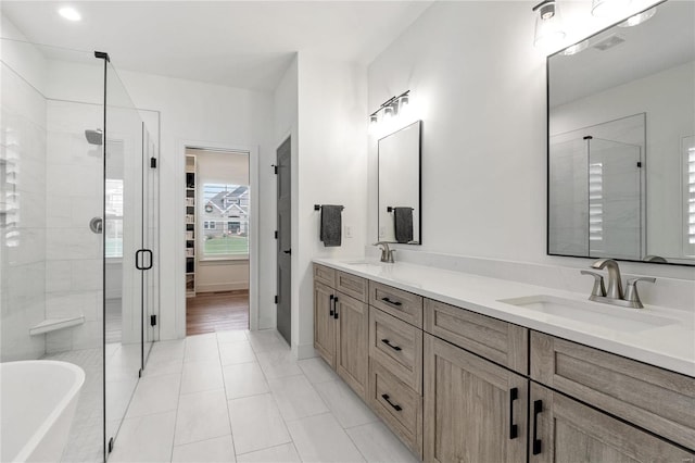 bathroom featuring tile patterned flooring, vanity, and plus walk in shower