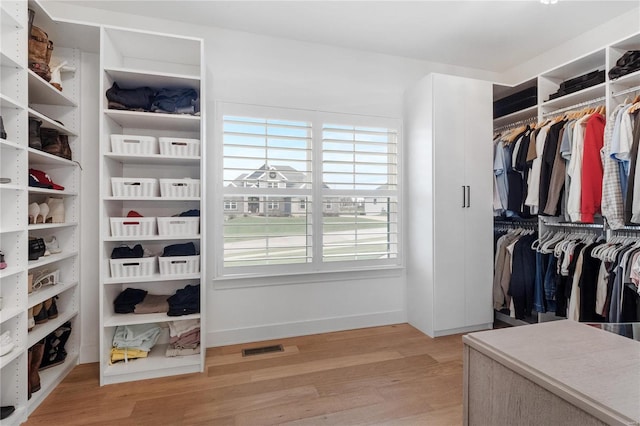 walk in closet featuring light hardwood / wood-style flooring