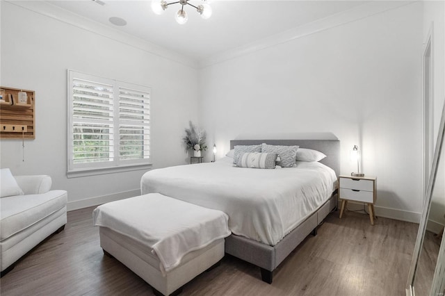 bedroom with hardwood / wood-style flooring and ornamental molding