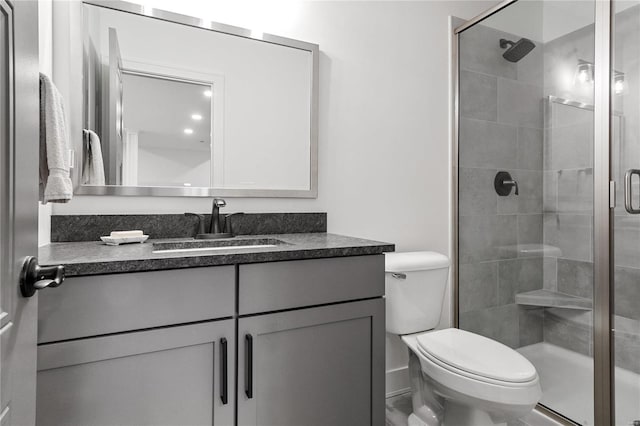 bathroom with vanity, toilet, and walk in shower