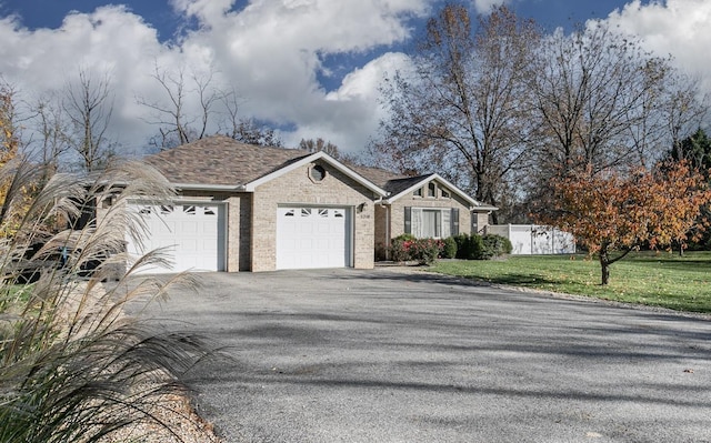 view of front of house with a garage and a front lawn