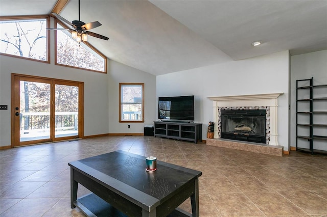 living room featuring a tile fireplace, high vaulted ceiling, tile patterned floors, ceiling fan, and beam ceiling