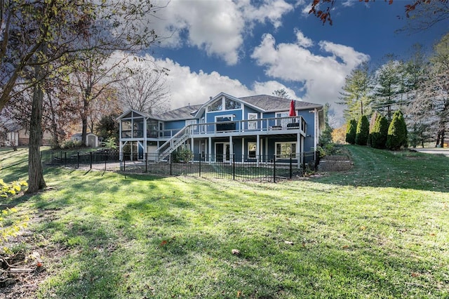 back of house with a lawn and a wooden deck