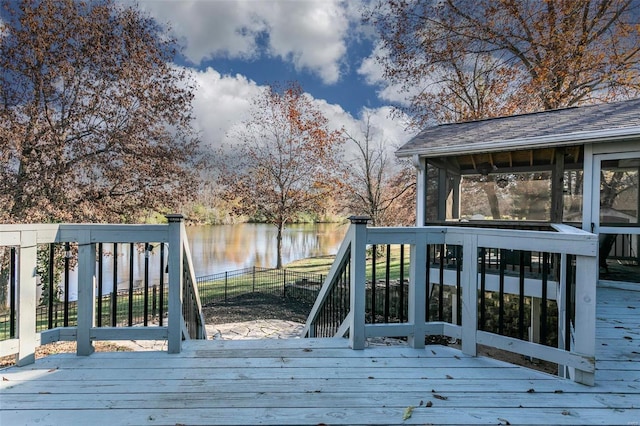 wooden deck with a sunroom and a water view