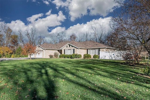 ranch-style home with a garage and a front yard