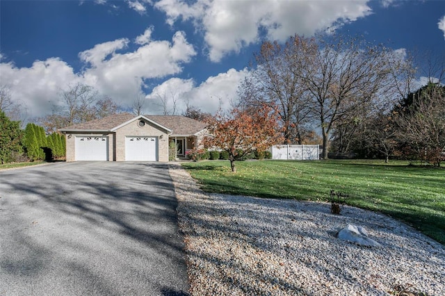 ranch-style home featuring a garage and a front lawn