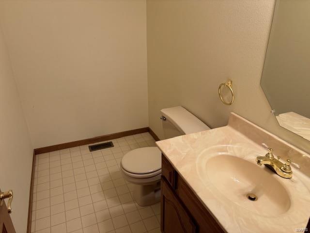 bathroom featuring tile patterned flooring, vanity, and toilet