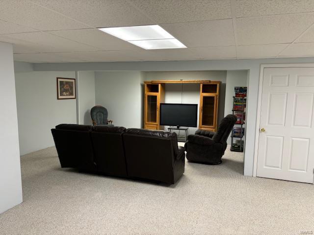 living room with carpet and a drop ceiling