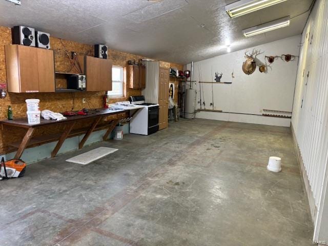 garage with a workshop area and gas water heater