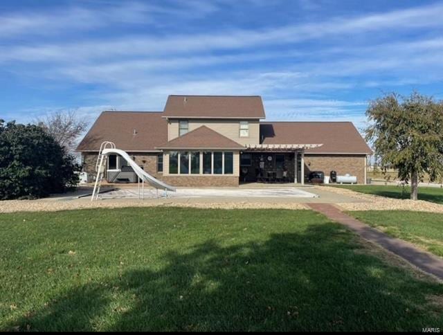 back of house with a lawn