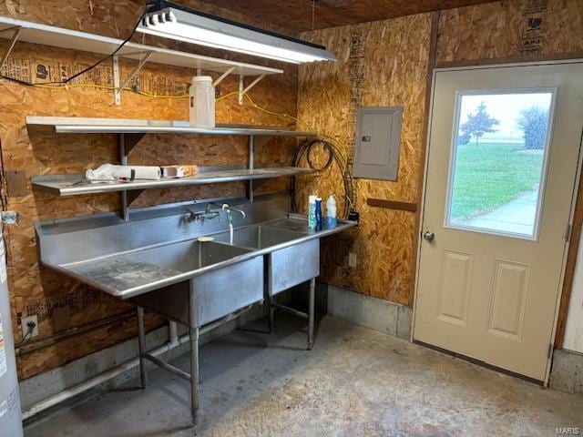 interior space with concrete floors and electric panel