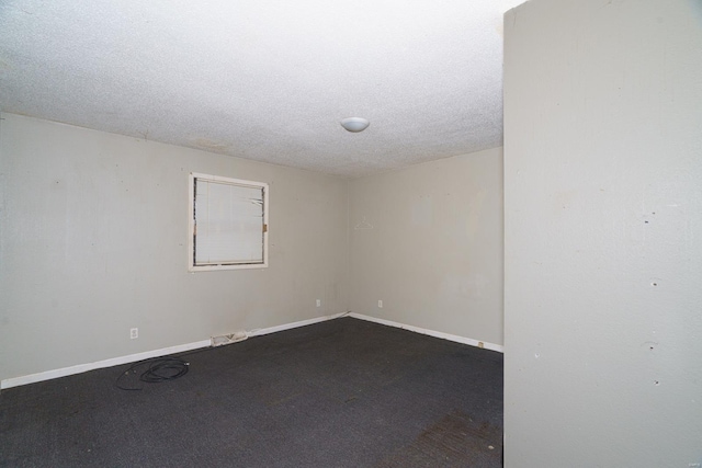 carpeted spare room featuring a textured ceiling