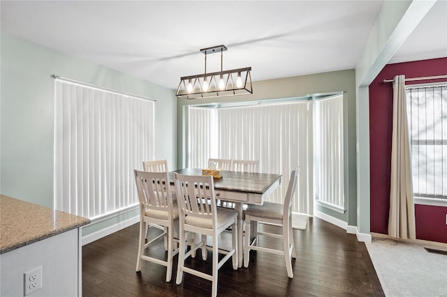 dining room featuring plenty of natural light and dark hardwood / wood-style floors