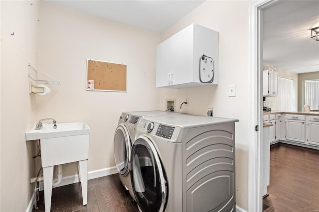 washroom featuring cabinets, dark hardwood / wood-style flooring, and independent washer and dryer