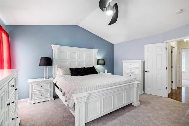 carpeted bedroom featuring ceiling fan and lofted ceiling