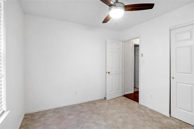 unfurnished bedroom featuring ceiling fan and light colored carpet