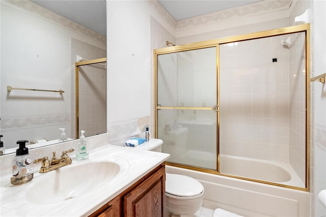 full bathroom featuring vanity, bath / shower combo with glass door, and toilet