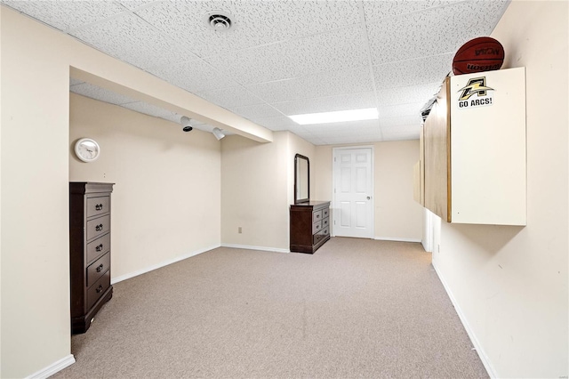 basement with carpet flooring and a drop ceiling