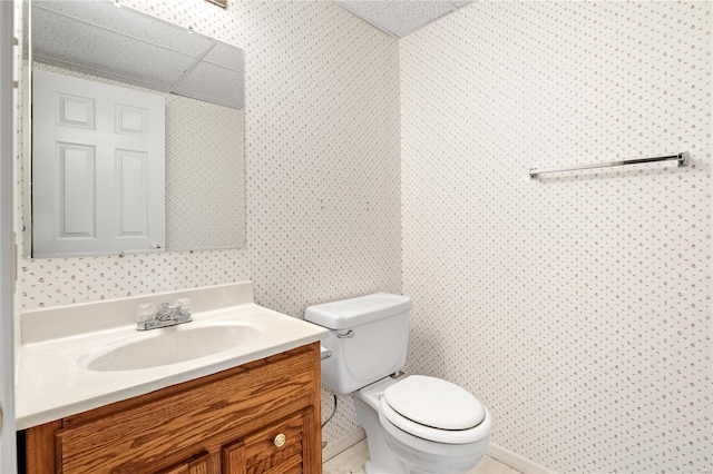 bathroom featuring vanity, a textured ceiling, and toilet