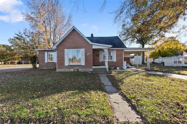 bungalow-style house with a front yard and a carport