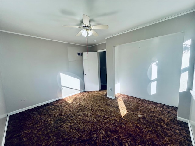 unfurnished bedroom with a ceiling fan, carpet, baseboards, and ornamental molding