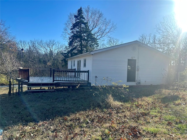 rear view of property featuring a wooden deck