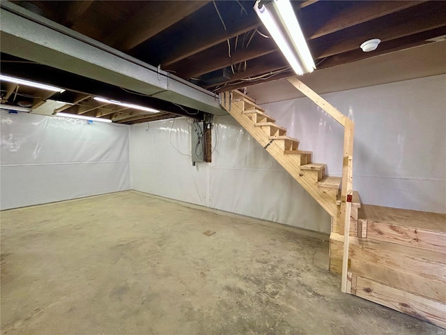 unfinished below grade area featuring stairs