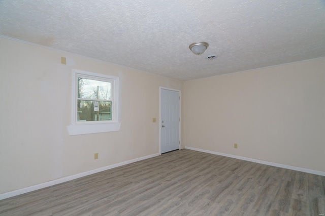 empty room featuring hardwood / wood-style floors and a textured ceiling