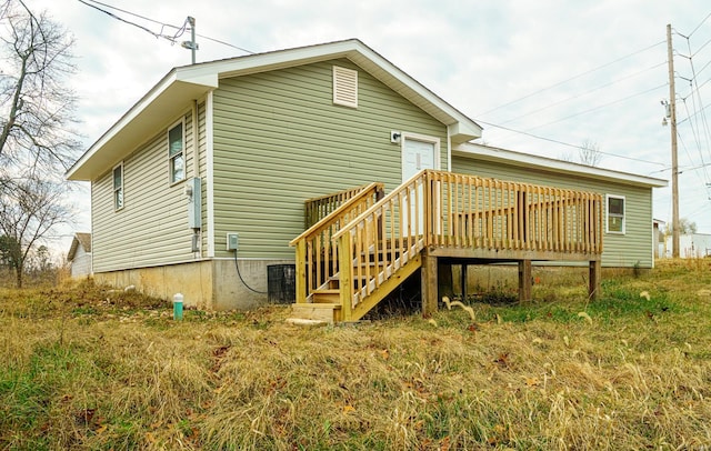 rear view of property with a wooden deck