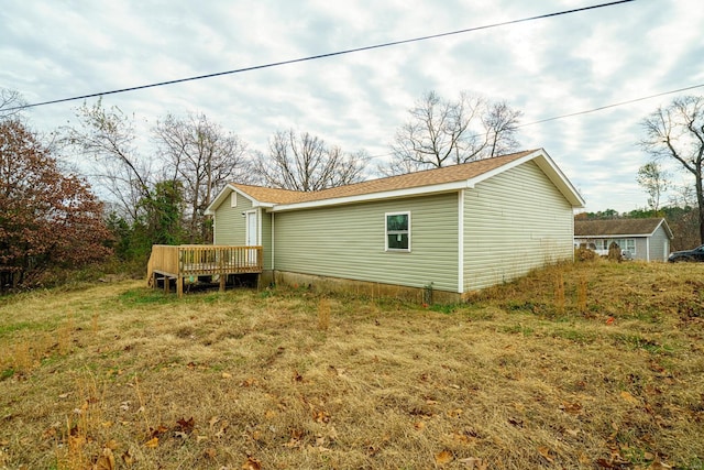 view of property exterior featuring a wooden deck