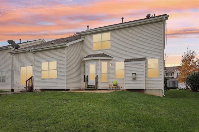 back house at dusk with a yard