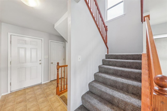 stairway with tile patterned flooring