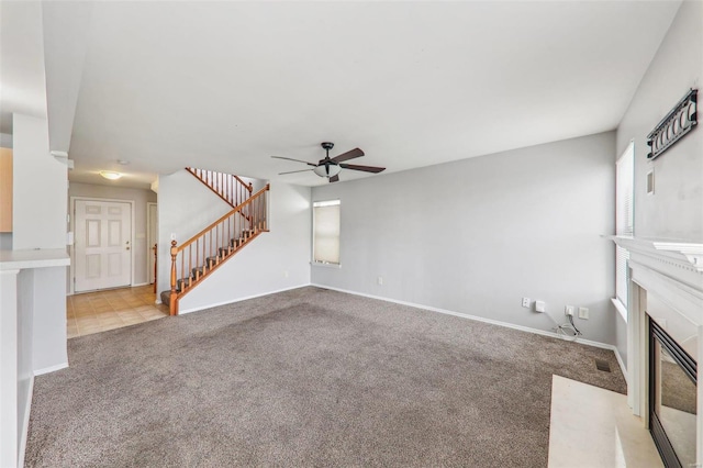 unfurnished living room with light carpet and ceiling fan