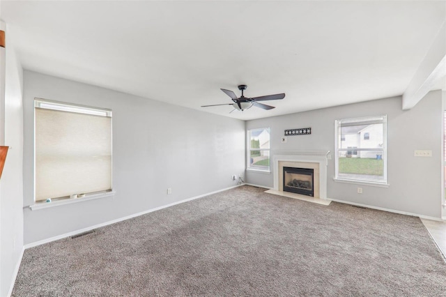 unfurnished living room featuring carpet flooring and ceiling fan