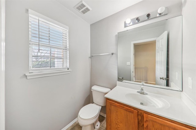 bathroom featuring tile patterned flooring, vanity, and toilet