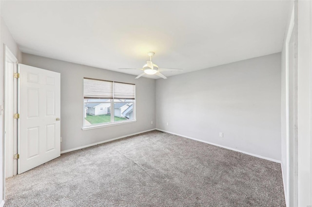 empty room with carpet flooring and ceiling fan