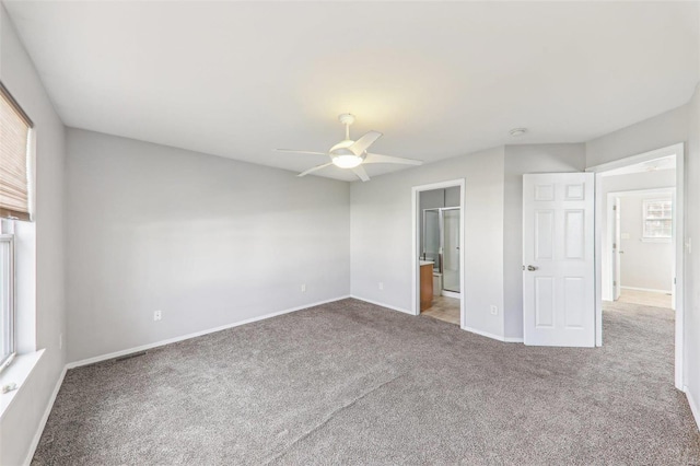 unfurnished bedroom featuring ceiling fan, a walk in closet, carpet floors, and a closet