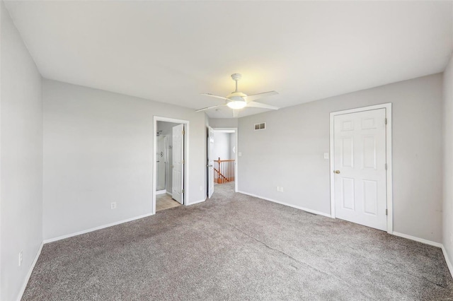 unfurnished bedroom with carpet floors, ensuite bath, and ceiling fan