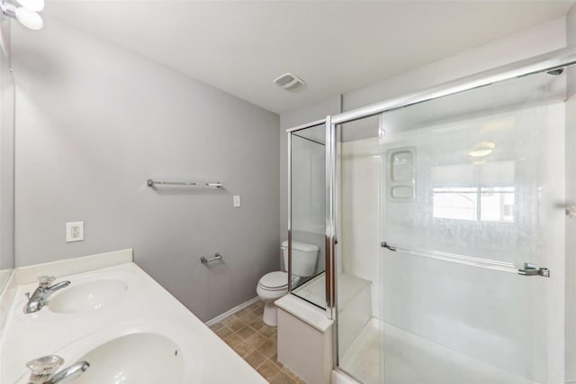 bathroom with toilet, vanity, and walk in shower