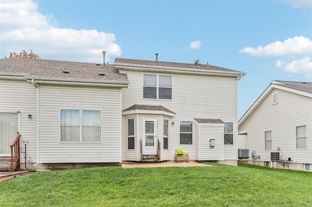 back of house featuring a lawn and central AC