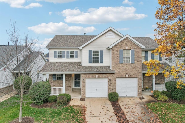 view of front of property with covered porch and a garage