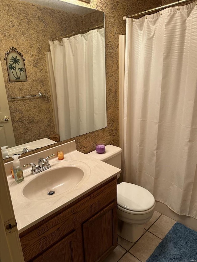 bathroom featuring tile patterned floors, vanity, and toilet