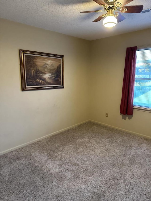 unfurnished room with carpet flooring, a textured ceiling, and ceiling fan