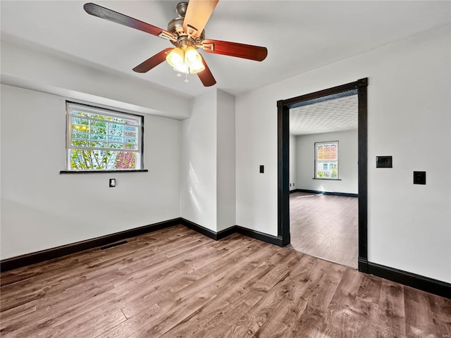 unfurnished room featuring hardwood / wood-style floors and ceiling fan