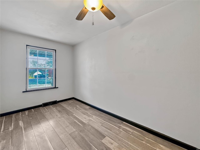 empty room featuring ceiling fan and light hardwood / wood-style flooring