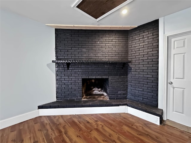 interior details featuring a fireplace and wood-type flooring