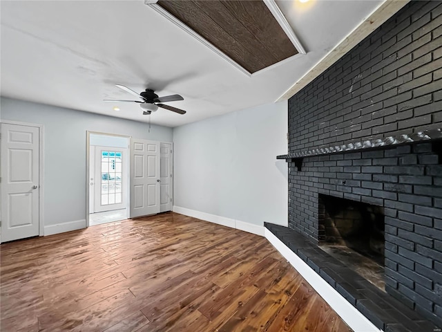 unfurnished living room with a fireplace, ceiling fan, and hardwood / wood-style floors