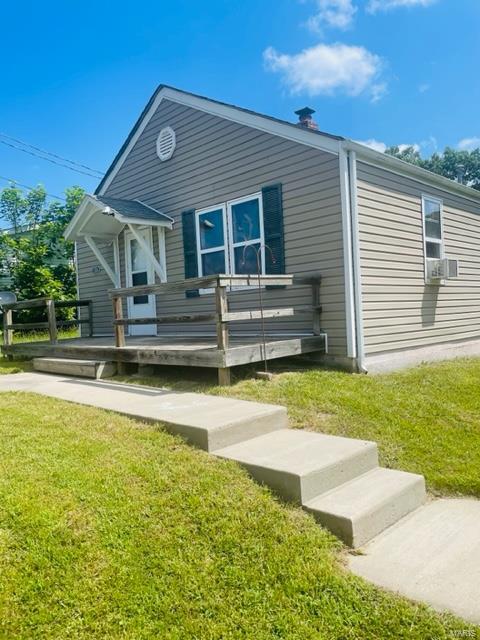 back of property featuring a porch and a lawn