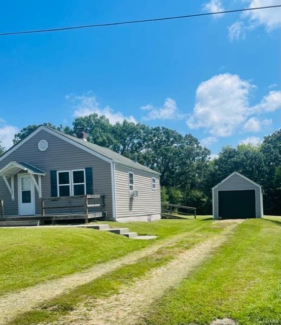 view of side of property with a garage, an outdoor structure, and a yard